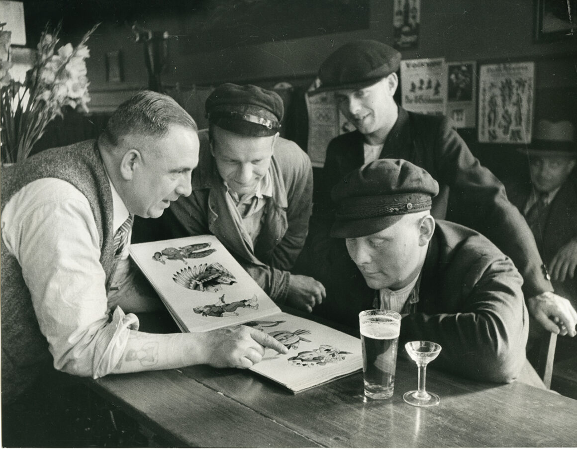 Christian Warlich shows off his flash book, c. 1936